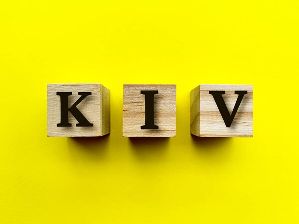 Alphabets of KIV on wooden blocks with yellow background. Conceptual
