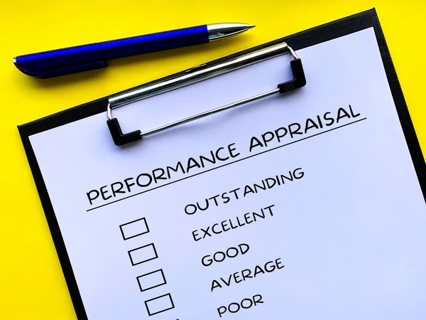 Top view of performance Appraisal checklist on clip board with yellow background. Performance review concept.