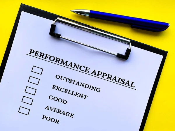 Top view of performance Appraisal checklist on clip board with yellow background. Performance review concept.