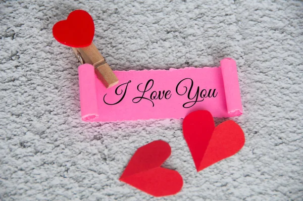 I love you text on torn pink paper with keyboard background. Romance and relationship concept.