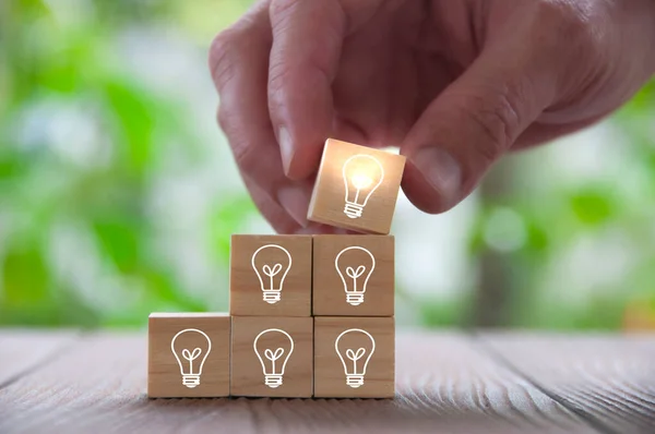Light bulbs on wooden blocks representing business ideas. Business idea concept
