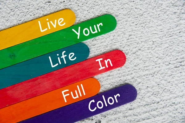 live your life in full color text on color sticks. Motivational concept