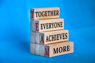 Team text on wooden block - Together, everyone achieves more. clipart