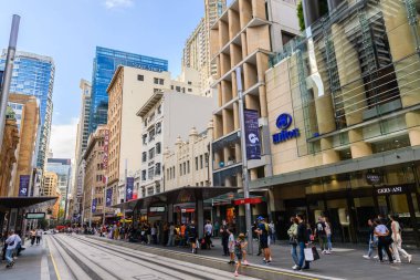 Sydney, Australia - April 16, 2022: George street viewed towards North with the Hilton hotel and QVB Light Rail station on the right on a day