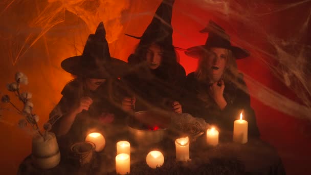 Three Young Witches Ritual Cauldron Taking Her Eyes Camera One — Vídeo de Stock