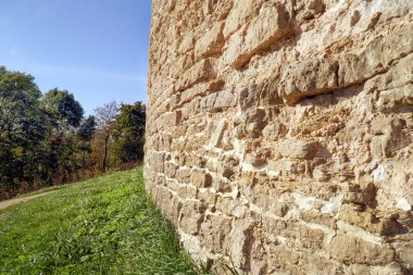 Farklı şekillerde taşlardan yapılmış eski kalenin taş duvarı.