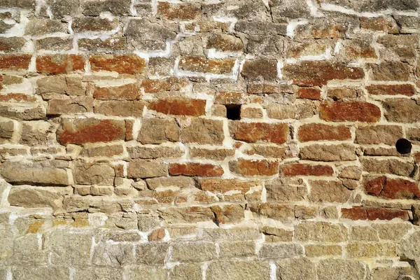 Pared de piedra marrón. antigua muralla de la fortaleza — Foto de Stock