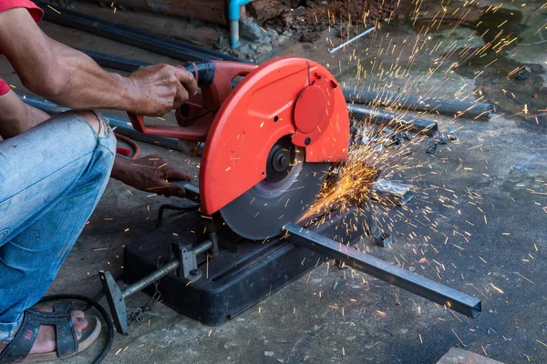 Worker cut steel with cut off wheel saw, cutting wheels.