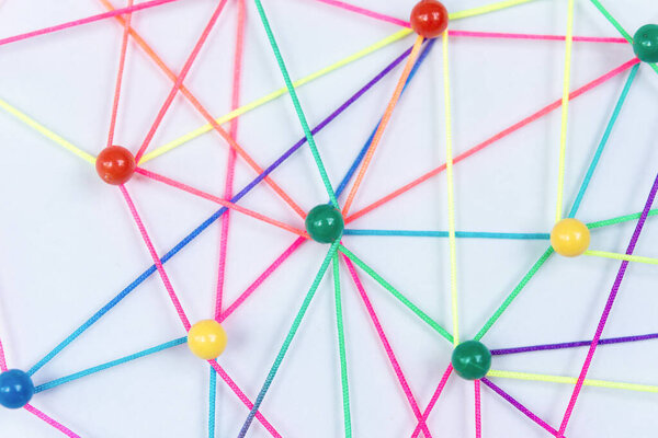 Linking entities, Blockchain, social media, Communications Network, The connection between the two networks. Network simulation on paper linked together by yarn