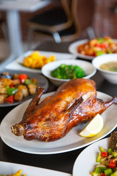 Food platter combo set of traditional Cantonese yum-cha Asian gourmet cuisine meal food dish on the white serving plate on the table, includes dishes of roast Peking duck, pork, fish, chicken