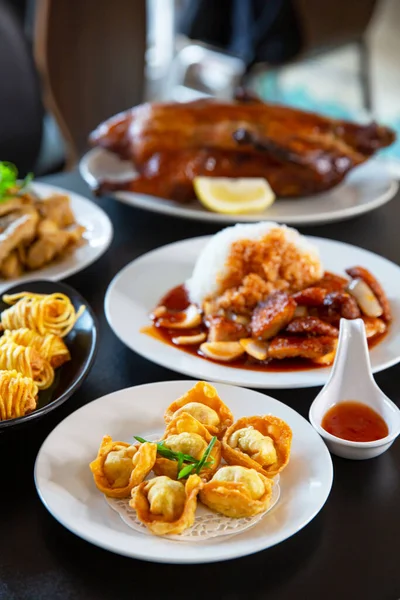 Food platter combo set of traditional Cantonese yum-cha Asian gourmet cuisine meal food dish on the white serving plate on the table, includes dishes of duck, pork, fish, chicken, fried wonton