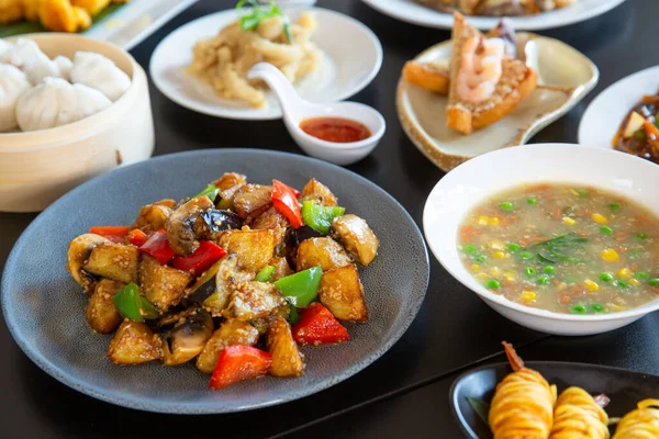 Food platter combo set of traditional Cantonese yum-cha Asian gourmet cuisine meal food dish on the white serving plate on the table, includes dishes of duck, pork, fish, chicken, fried vegetables