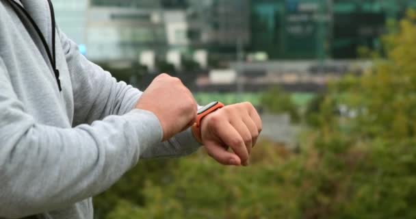 Fitness muž se podívat na chytré hodinky na venkovní sportovec cvičení zařízení app lano — Stock video