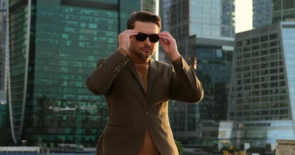 男は眼鏡をかけニューヨークの超高層ビルのオフィスビルを見て — ストック動画