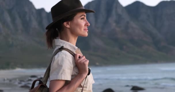Menina viajante em um chapéu goza do pôr do sol no oceano na áfrica — Vídeo de Stock