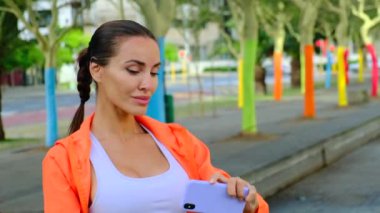 Havalı, neşeli bir kızın, elinde akıllı bir telefonla sevgilisiyle görüntülü konuşma yapıp selfie çektiği portresi. Kadınlar yaz günü sahilde selfie çekiyorlar. Kız görüntülü konuşuyor.