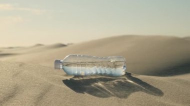 bottle with water on the desert. a plastic water bottle lies on the hot sand in the desert under the hot sun, alone in the middle of the desert sand. Hand takes a plastic water bottle in the desert.