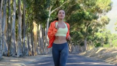 Good sporty morning. Cheerful girl running in park, healthy lifestyle. Young fitness sport woman running and Sportive people training in a urban area. young attractive fitness girl jogging