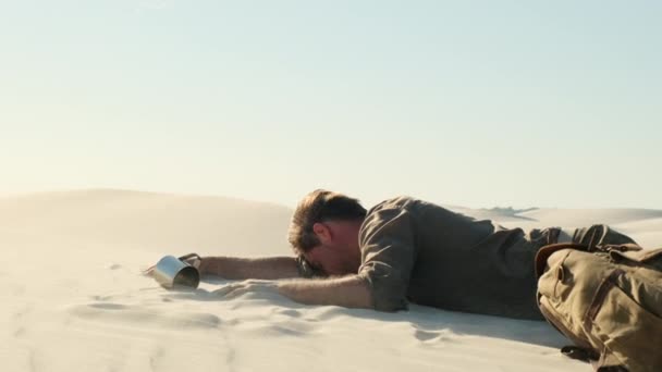 Man Feels Thirst Drinks Water Desert Mans Hand Lies Sand — Stock video