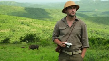 Erkek fotoğrafçı, turistik araçtan profesyonel kamerayla tropikal safaride fotoğraf çekiyor. Baharda gün doğumunda doğa fotoğrafçısı. Fotoğraf çeken.