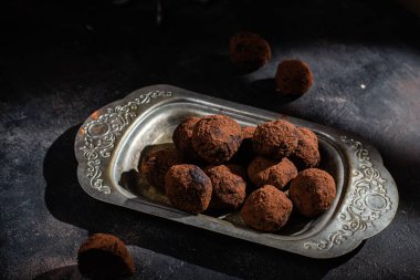 Dark chocolate truffle on dark background