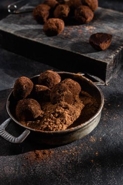 Dark chocolate truffle on dark background