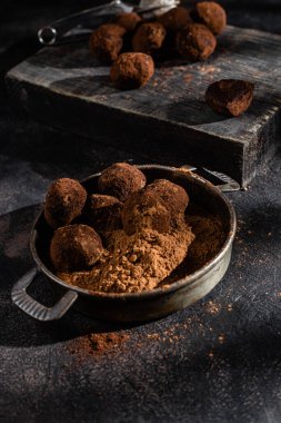 Dark chocolate truffle on dark background