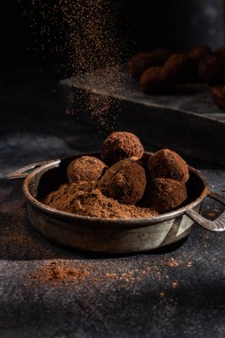 Dark chocolate truffle on dark background