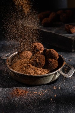 Dark chocolate truffle on dark background