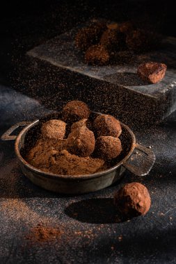 Dark chocolate truffle on dark background
