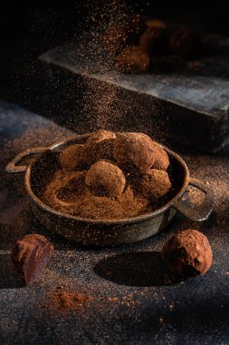 Dark chocolate truffle on dark background
