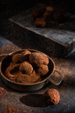 Dark chocolate truffle on dark background