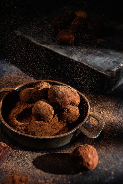 Dark chocolate truffle on dark background