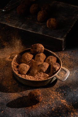 Dark chocolate truffle on dark background