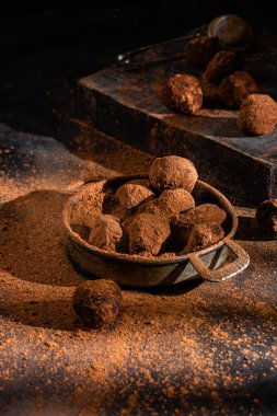 Dark chocolate truffle on dark background
