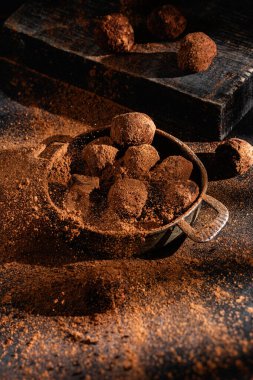 Dark chocolate truffle on dark background