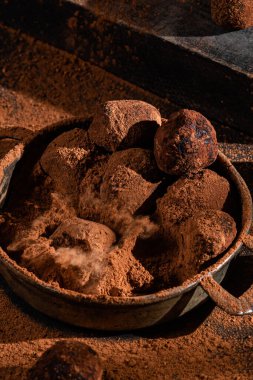 Dark chocolate truffle on dark background