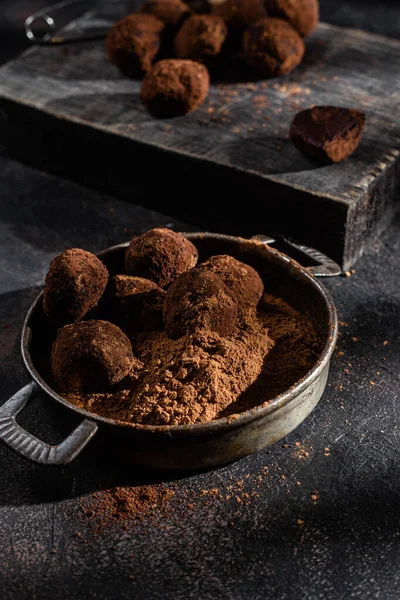 Dark chocolate truffle on dark background