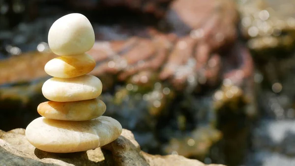 The Balance Stones are stacked as pyramids in a soft natural bokeh background, representing the calm philosophical concept of Jainism\'s wellness.