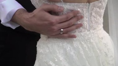 Gelin ve damat. Genç çift kucaklaşması. Beyaz elbiseli kız ve takım elbiseli adam..