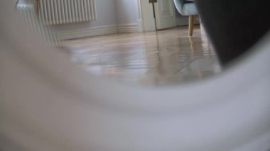 Two women in white and green pajamas are running barefoot at home on the floor.
