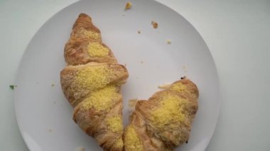 Two croissants in a plate. Breakfast for a couple. Baking crumbs.