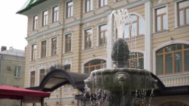Palace hotel building in a city. Fountain in yard. Luxury apartment architecture