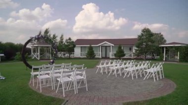 Decorated wedding ceremony outside. Wedding circle round arch with flowers.