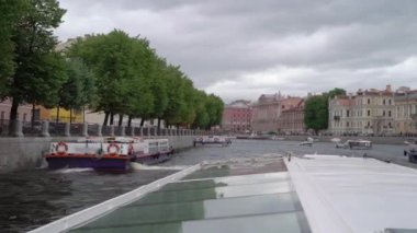 Sailing passenger touristic ship in a city. River tour in Saint-Petersburg.