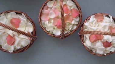 White and pink rose petals in a wicker basket. Throw petals at wedding ceremony.