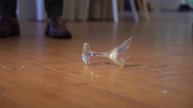 Broken glass from cocktail, wine or champagne on the floor. Shards of glass.