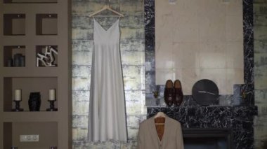 The brides wedding dress is white long. The grooms suit.