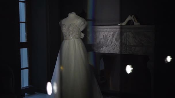 Wedding dress, white bridal gown and shoes on high heels hanging. Morning bride. — 비디오