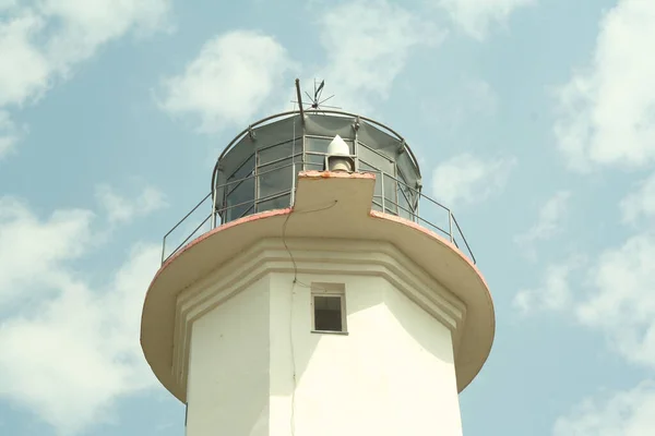 White lighthouse, close-up. Lighthouse on the blue sky background with white clouds for branding, calendar, multicolor card, banner, cover, header for website. High quality photo